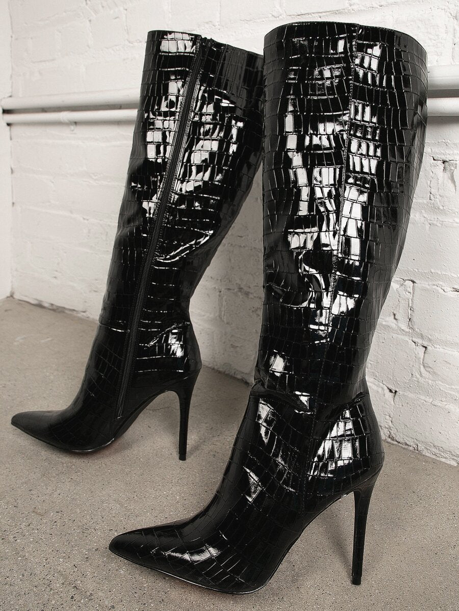 Women's black pointy toe stiletto heel boots featuring a side zipper closure and sleek faux leather finish.
