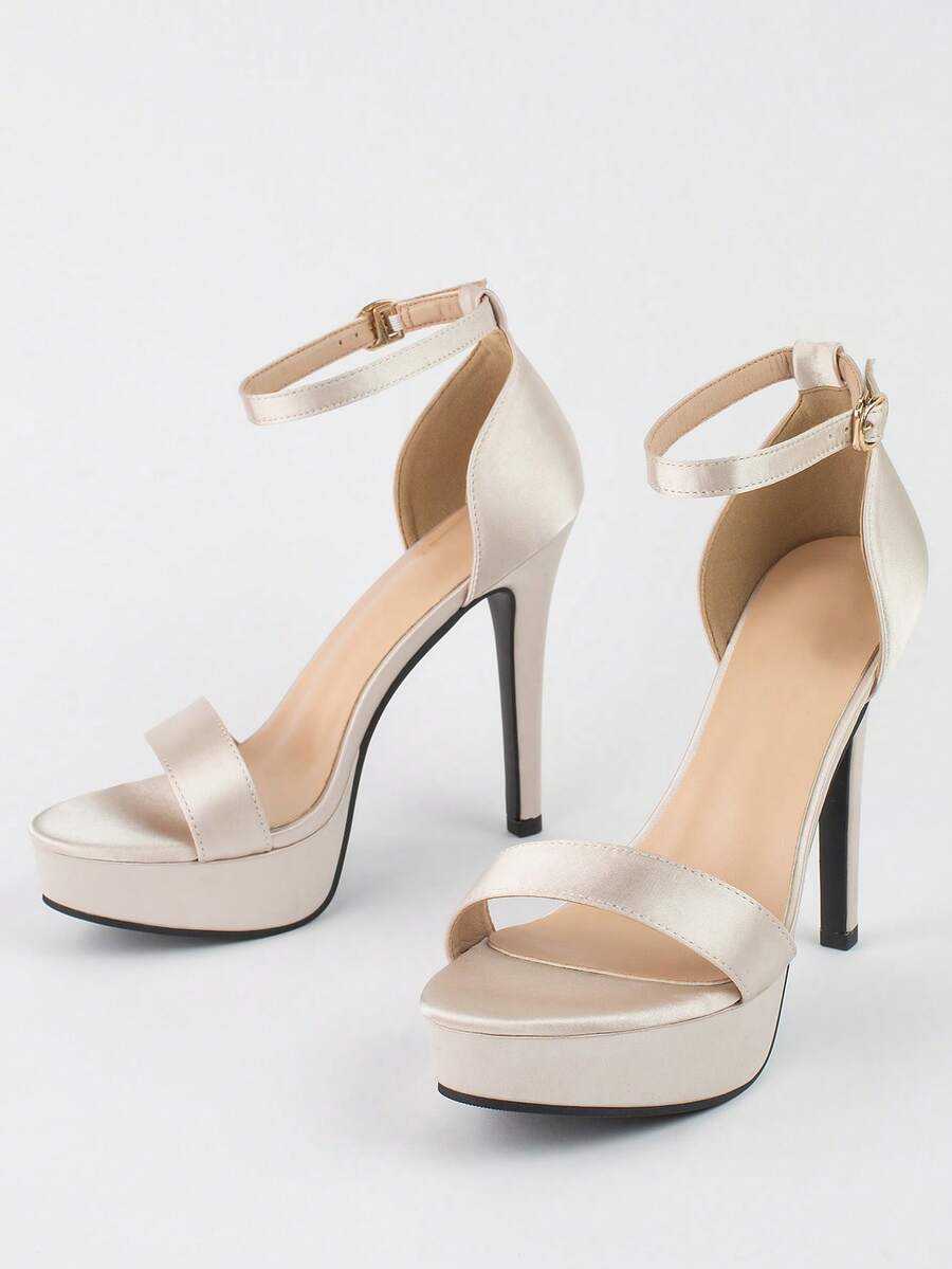 Women's open-toe platform stiletto heeled sandals featuring an ankle strap with rhinestone buckle detail.