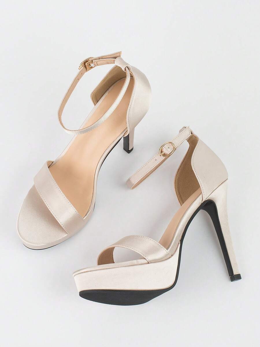 Women's open-toe platform stiletto heeled sandals featuring an ankle strap with rhinestone buckle detail.