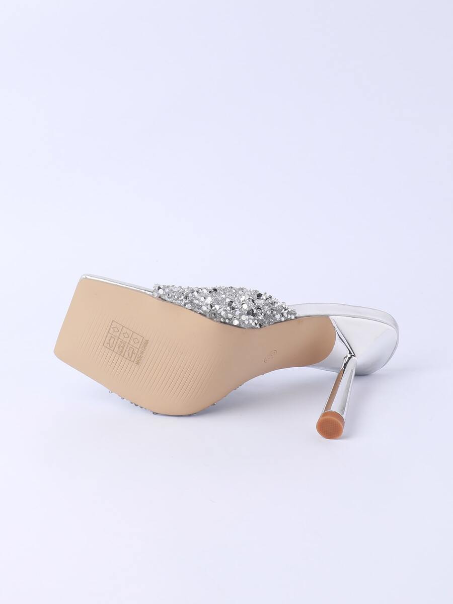 Women's slip-on high heel sandals featuring sparkling rhinestones, an open square toe, and a stiletto heel.