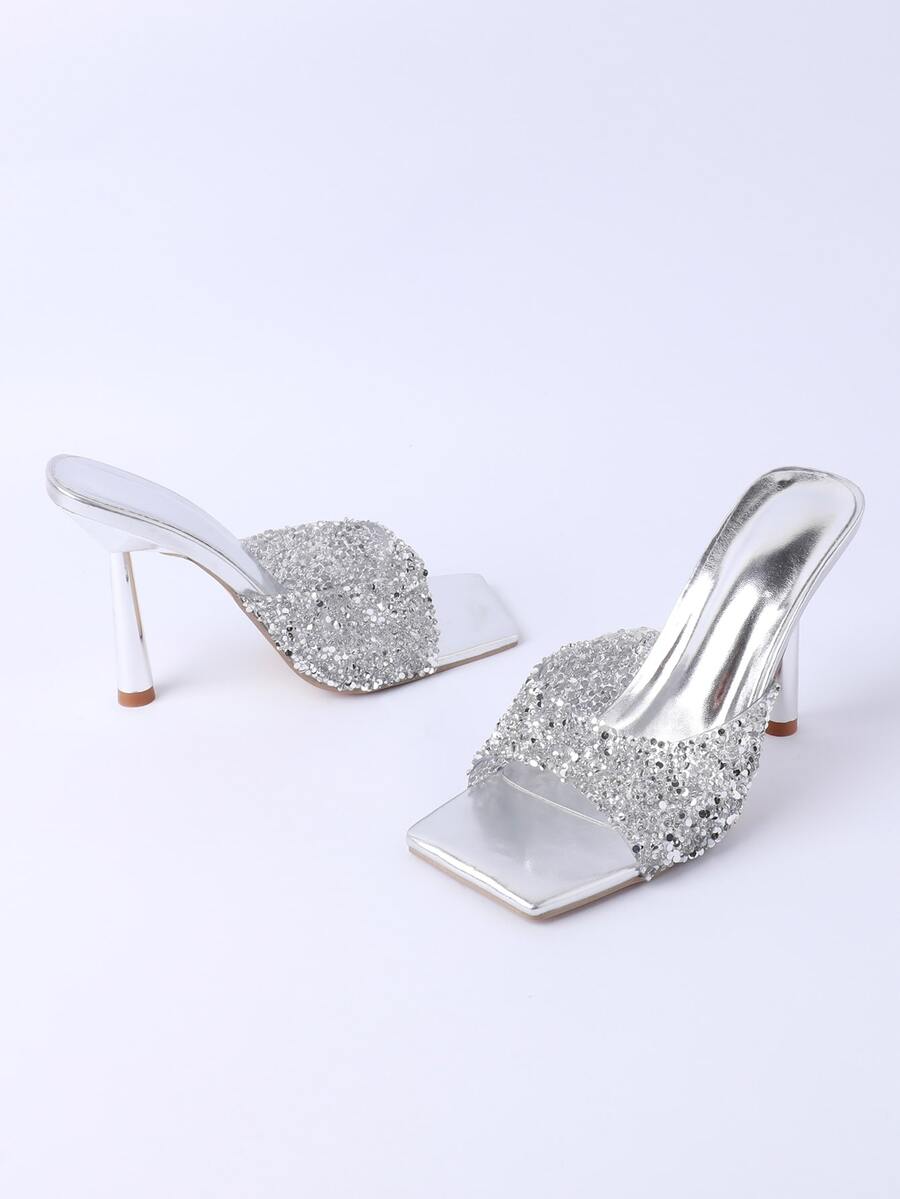 Women's slip-on high heel sandals featuring sparkling rhinestones, an open square toe, and a stiletto heel.