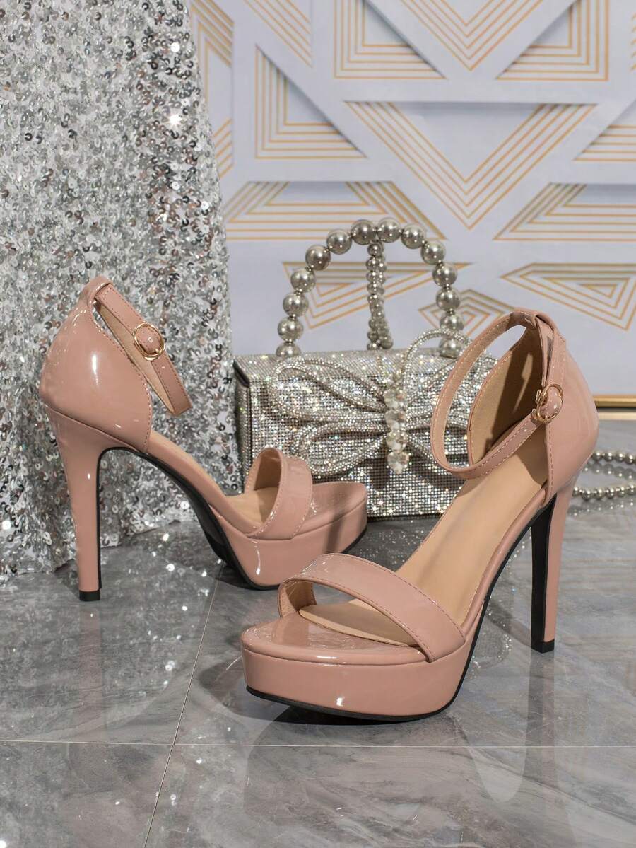 Women's open-toe platform stiletto heeled sandals featuring an ankle strap with rhinestone buckle detail.