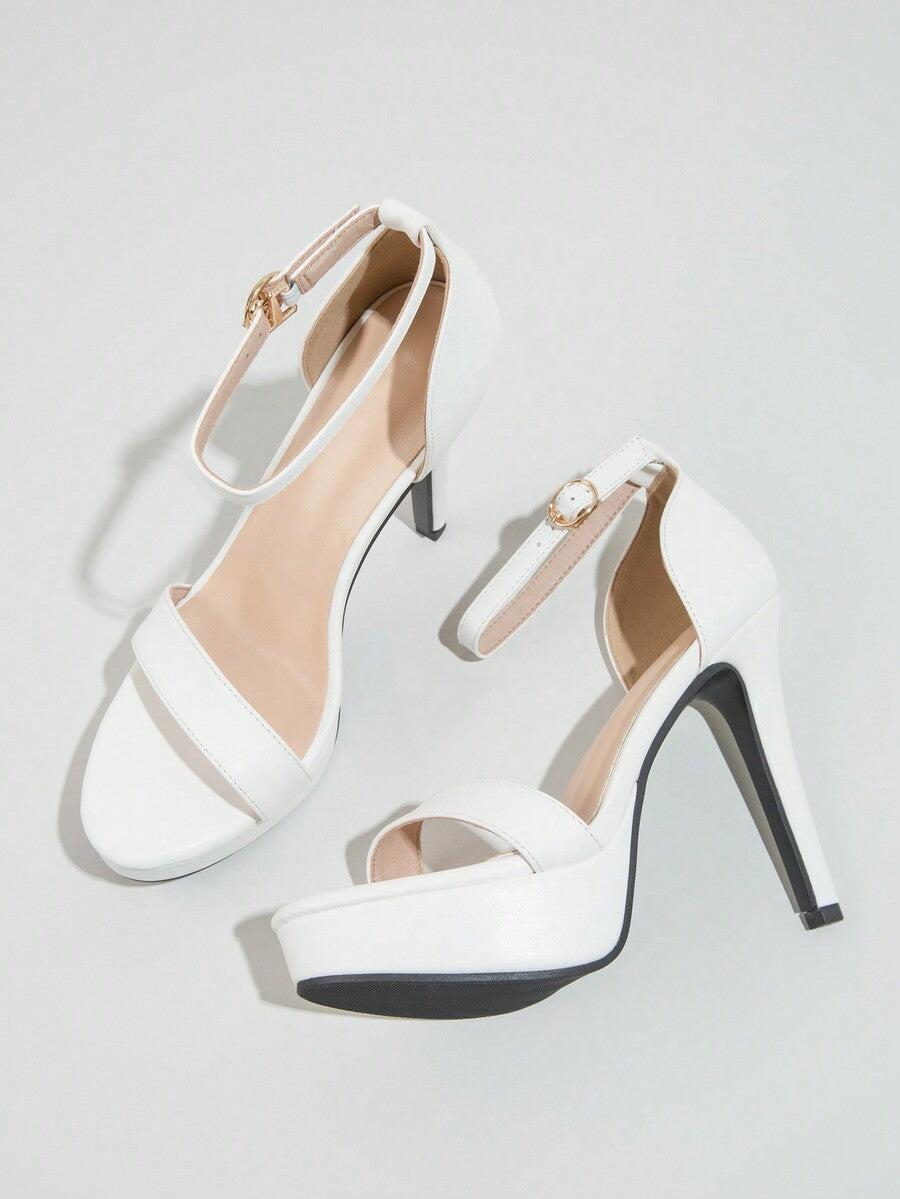 Women's open-toe platform stiletto heeled sandals featuring an ankle strap with rhinestone buckle detail.