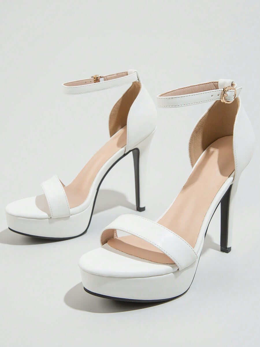 Women's open-toe platform stiletto heeled sandals featuring an ankle strap with rhinestone buckle detail.