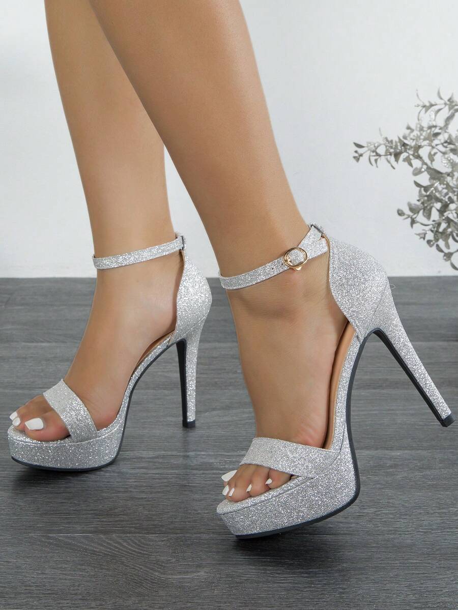 Women's open-toe platform stiletto heeled sandals featuring an ankle strap with rhinestone buckle detail.