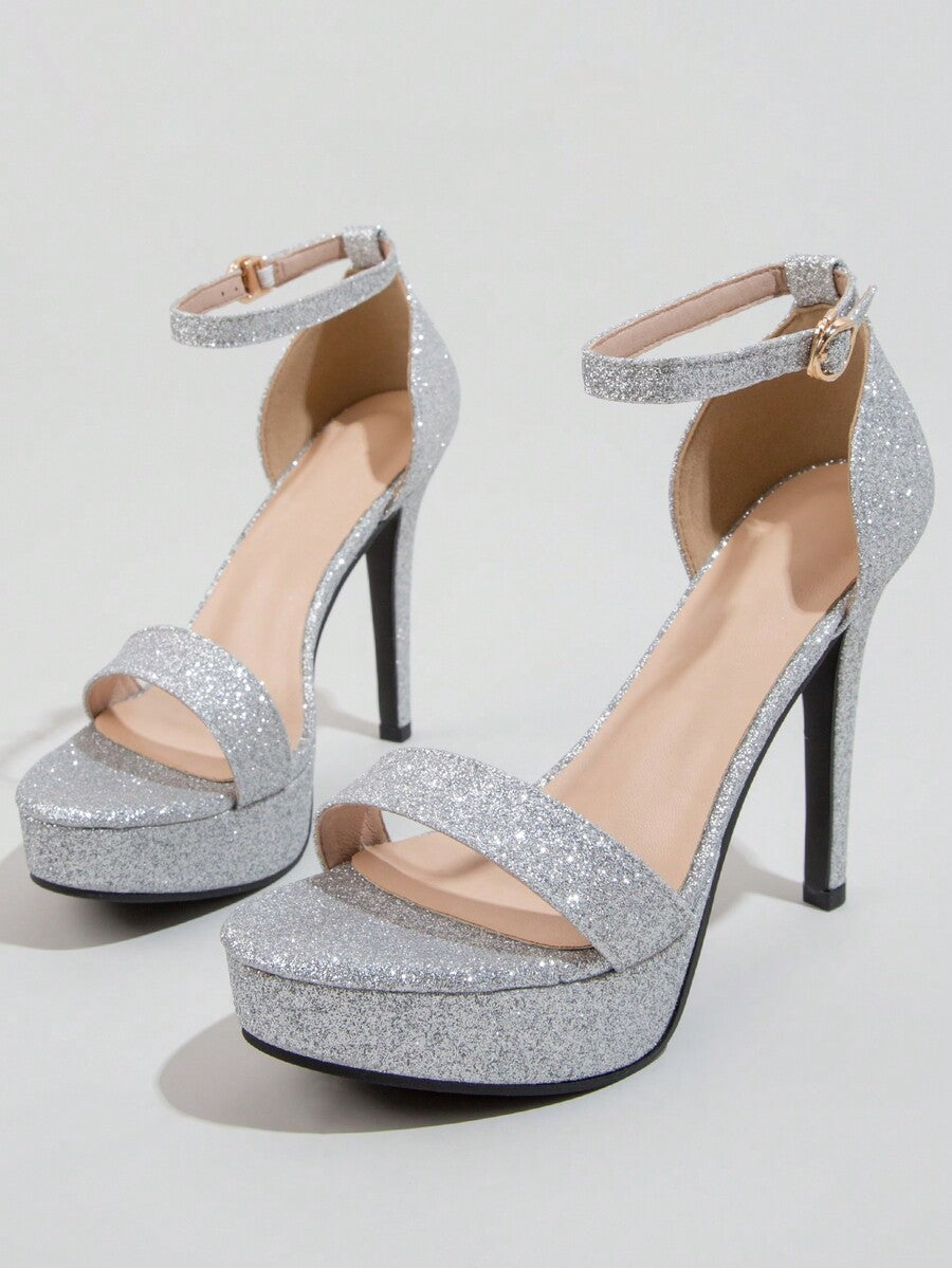 Women's open-toe platform stiletto heeled sandals featuring an ankle strap with rhinestone buckle detail.