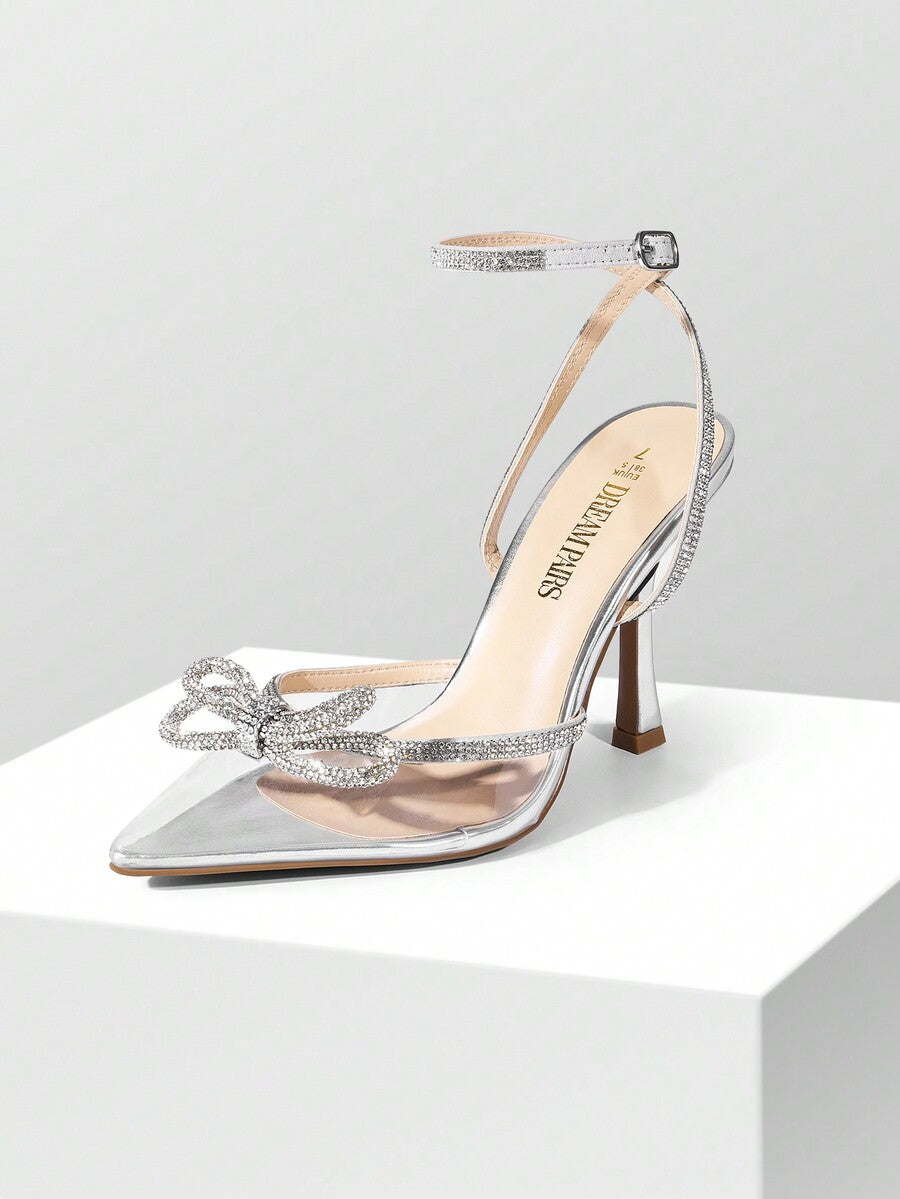 Women's rhinestone ankle strap high heels with pointed closed toe, strappy bow details, and stiletto heel for wedding and prom wear.