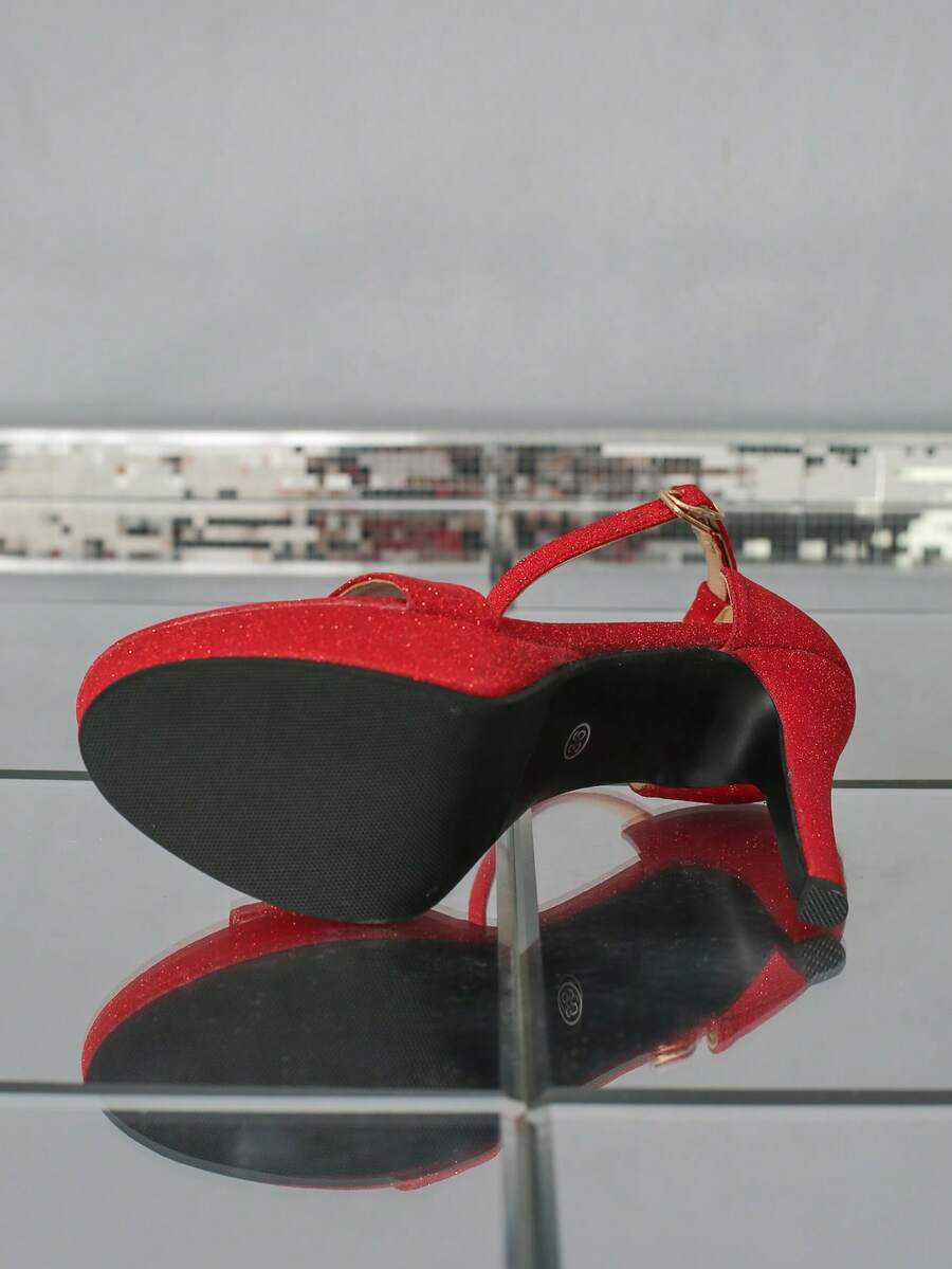 Women's open-toe platform stiletto heeled sandals featuring an ankle strap with rhinestone buckle detail.