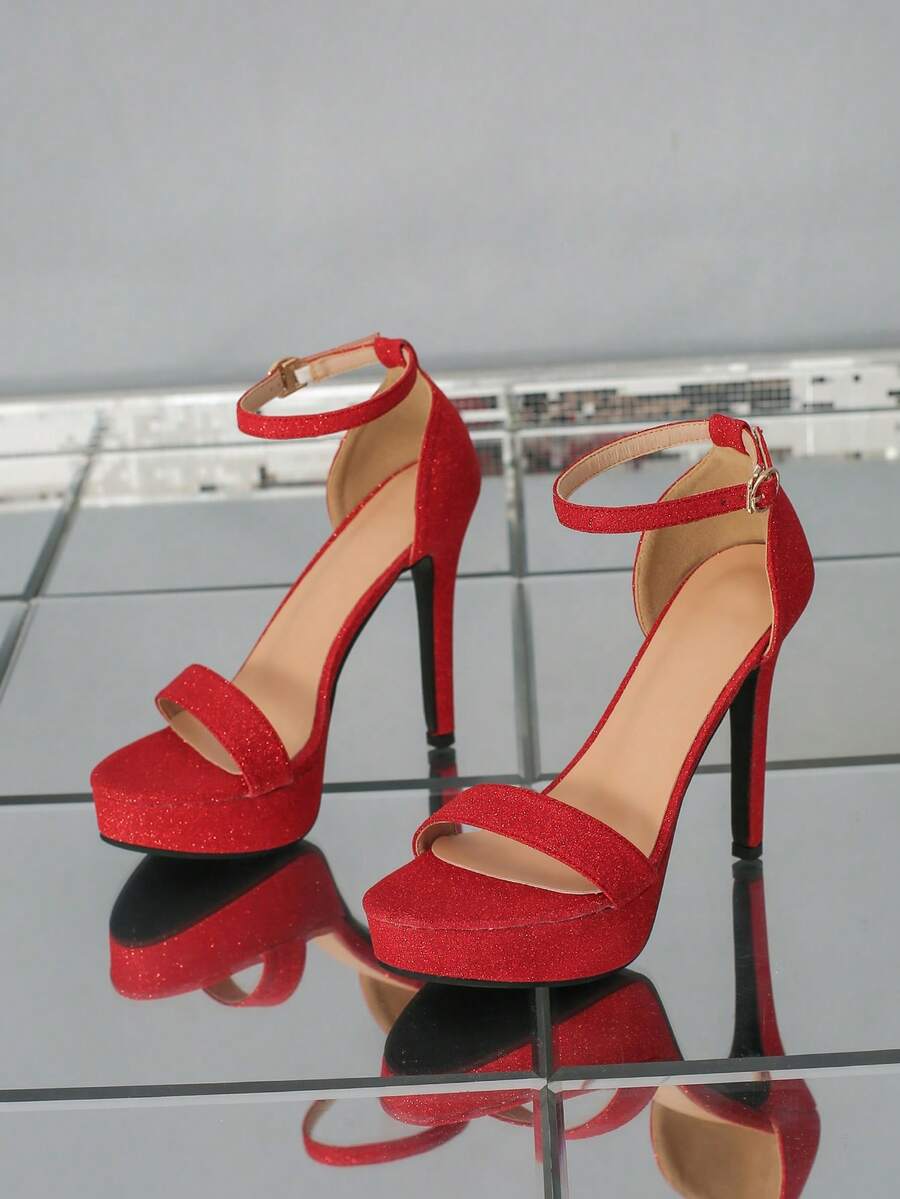 Women's open-toe platform stiletto heeled sandals featuring an ankle strap with rhinestone buckle detail.