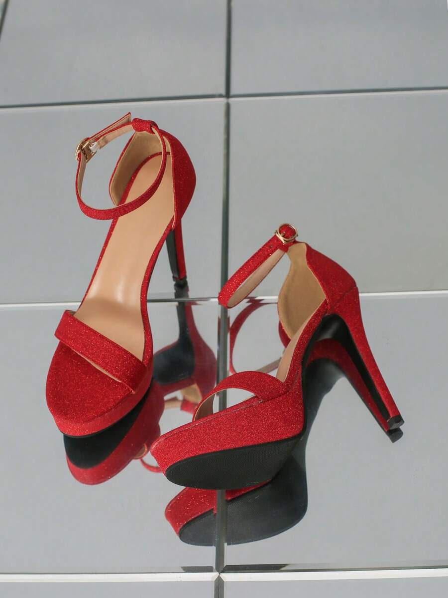 Women's open-toe platform stiletto heeled sandals featuring an ankle strap with rhinestone buckle detail.