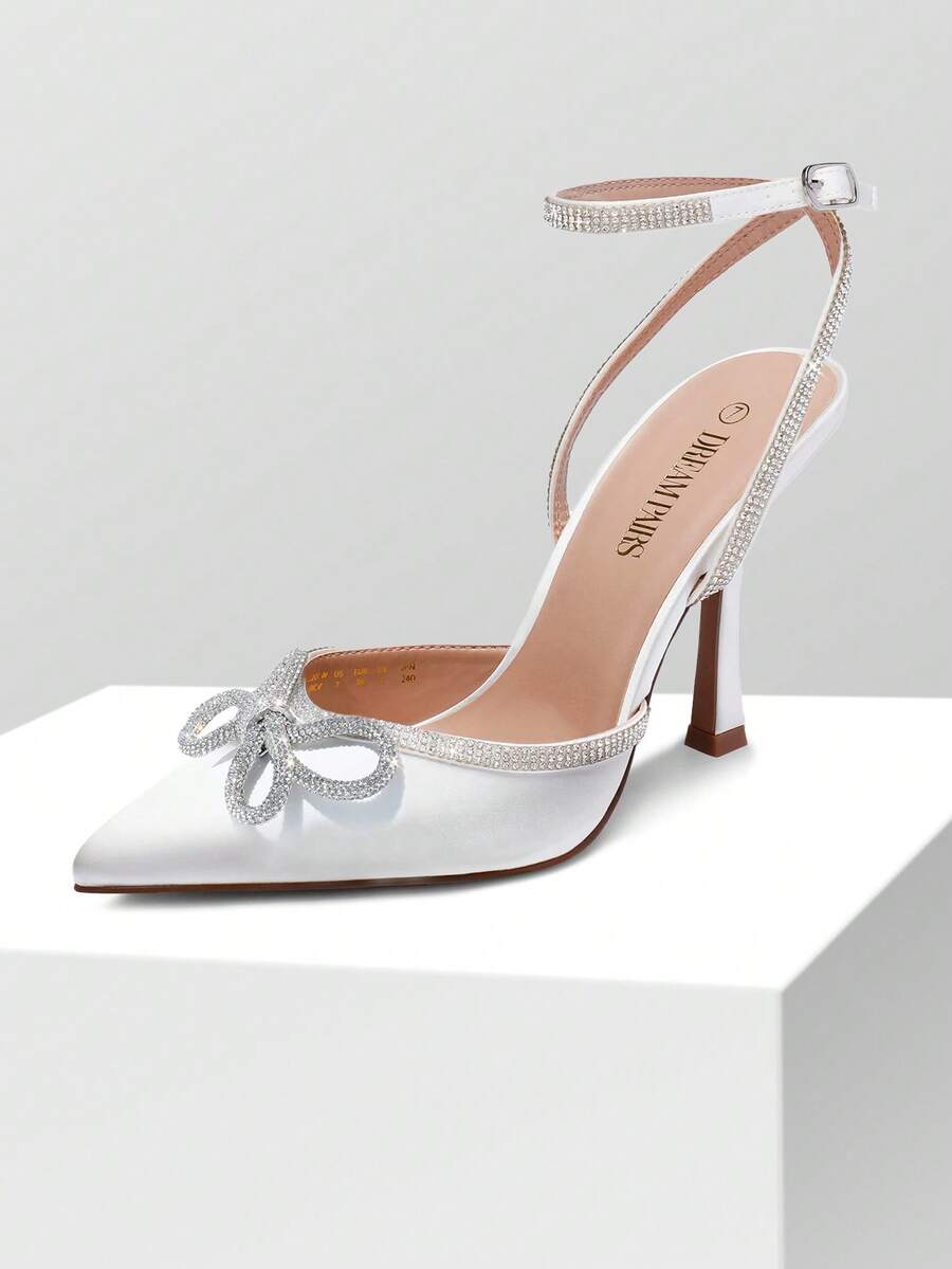 Women's rhinestone ankle strap high heels with pointed closed toe, strappy bow details, and stiletto heel for wedding and prom wear.