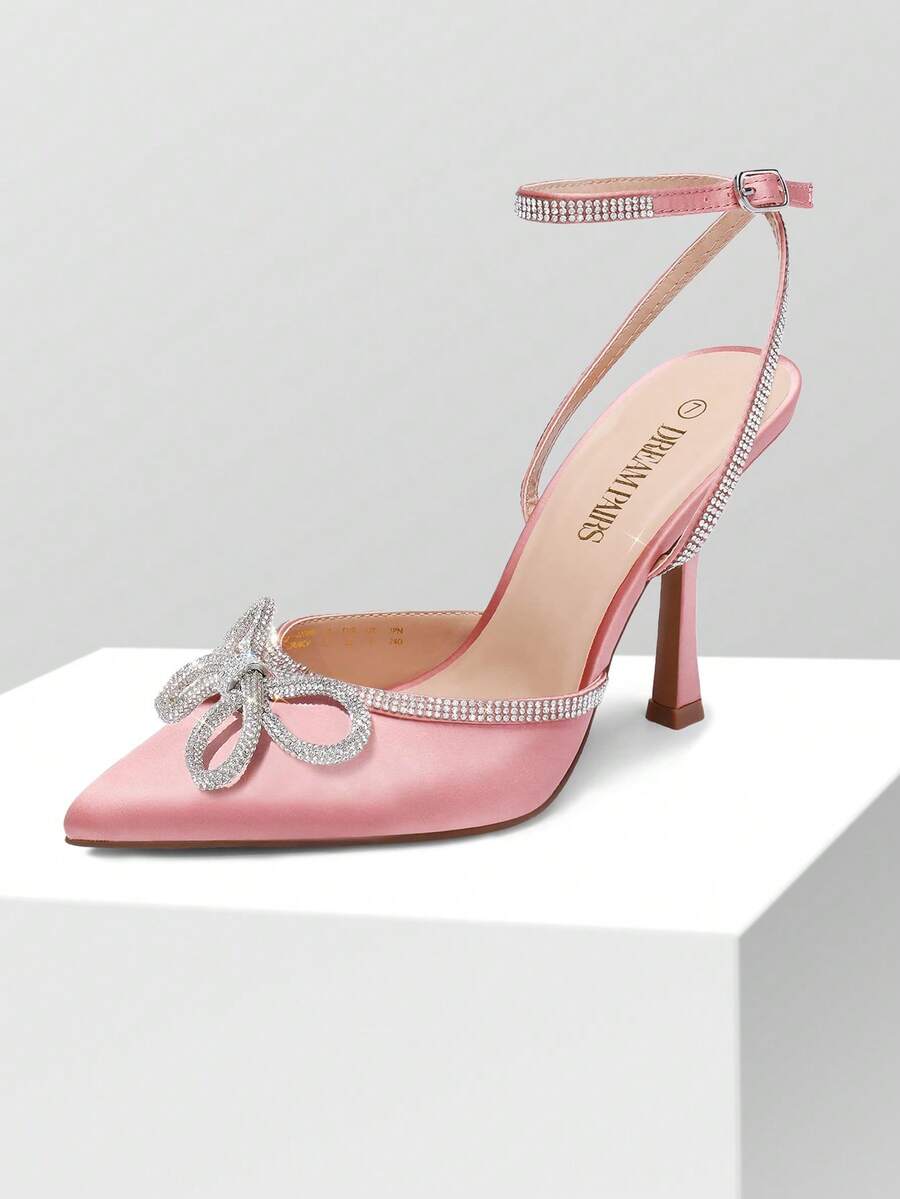 Women's rhinestone ankle strap high heels with pointed closed toe, strappy bow details, and stiletto heel for wedding and prom wear.