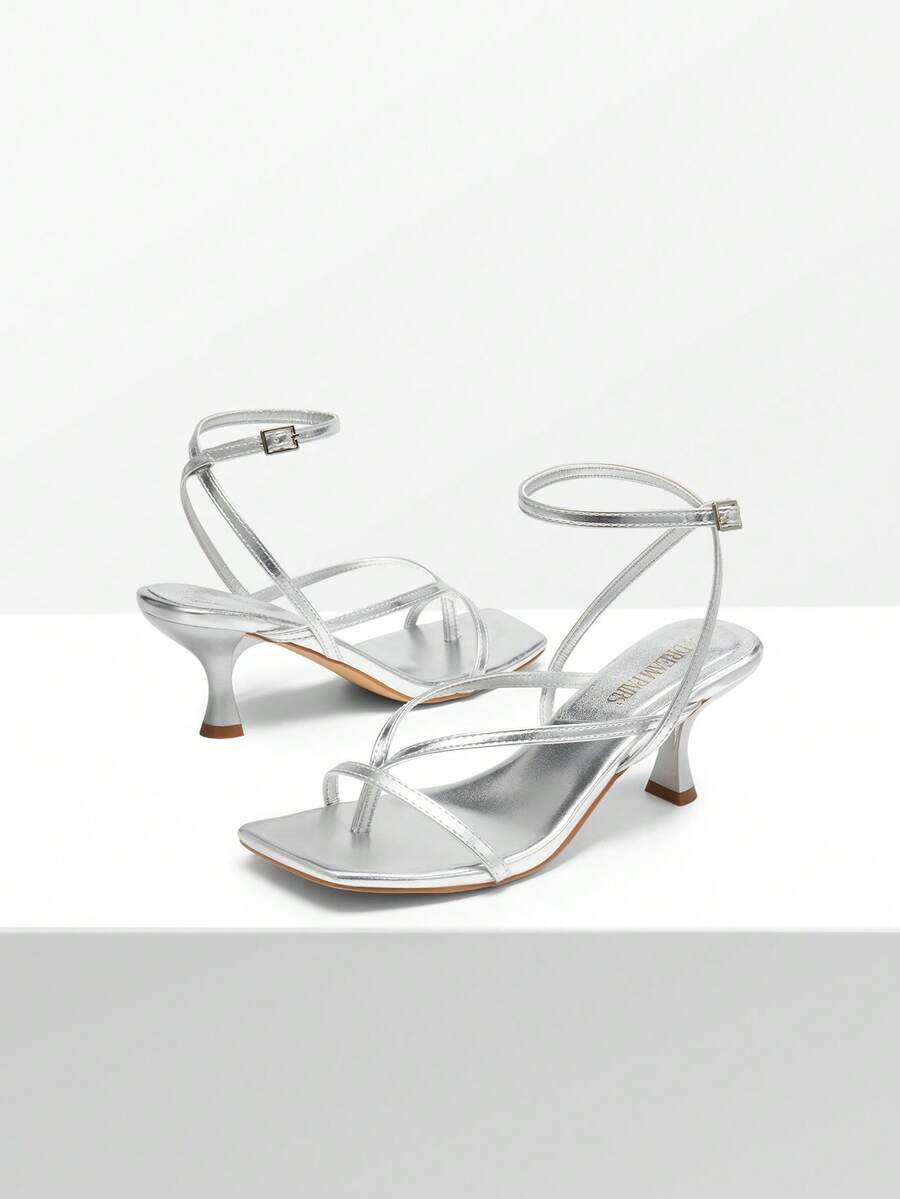 Pair of women's minimalist square toe kitten heeled thong sandals featuring slim ankle straps with buckle closure and sleek low heels.