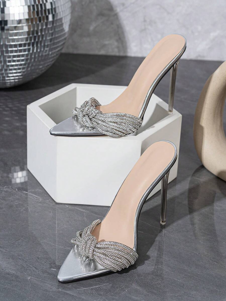Silver high heel sandals featuring open toe design, stiletto heel, sparkling rhinestone details, and wrap-around tie-up ankle straps.