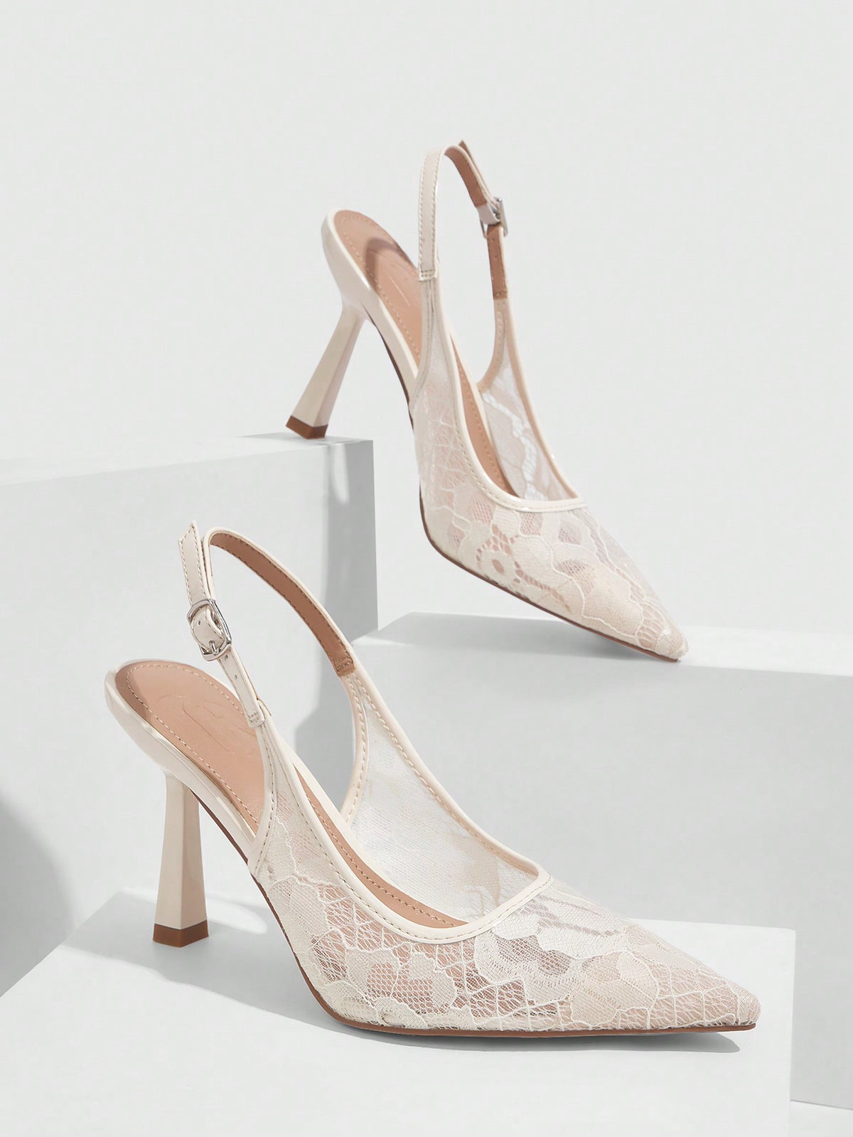 High heel wedding slingback pumps featuring delicate lace mesh upper, pointed toe, buckle strap, and stiletto heel