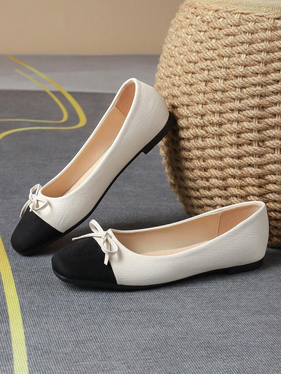 Pair of women's square toe slip-on flat shoes featuring a delicate bow detail and low vamp design.