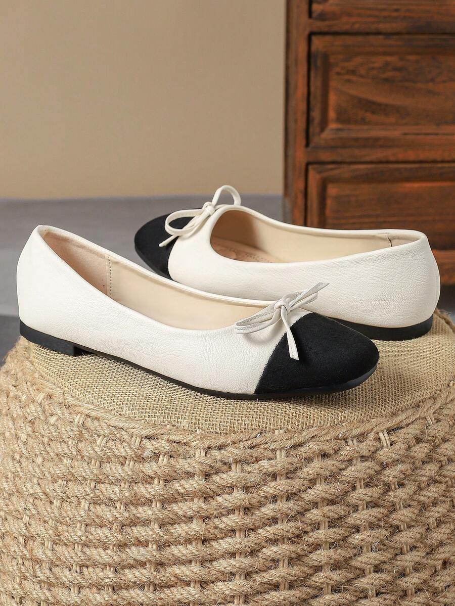 Pair of women's square toe slip-on flat shoes featuring a delicate bow detail and low vamp design.