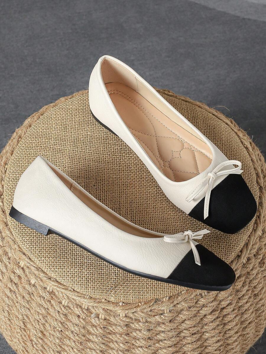 Pair of women's square toe slip-on flat shoes featuring a delicate bow detail and low vamp design.