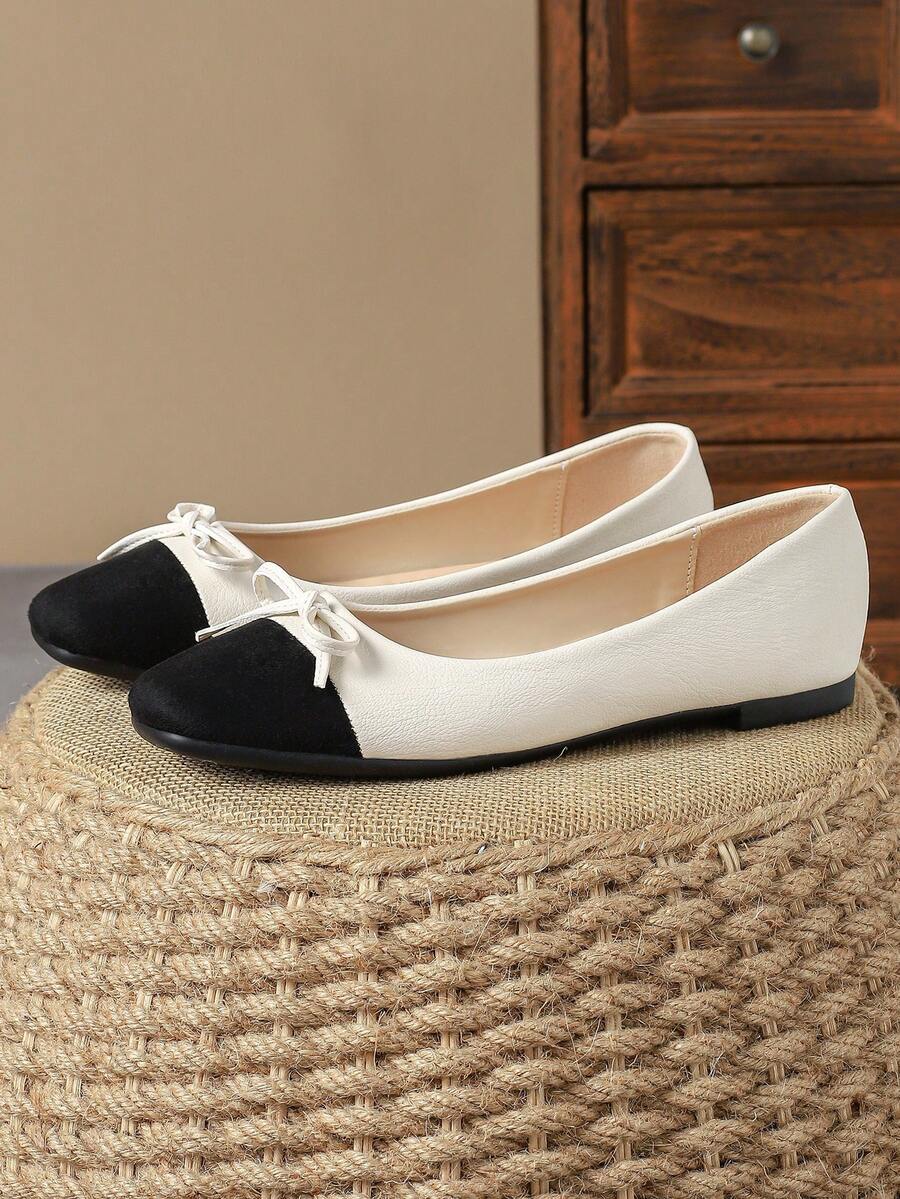 Pair of women's square toe slip-on flat shoes featuring a delicate bow detail and low vamp design.