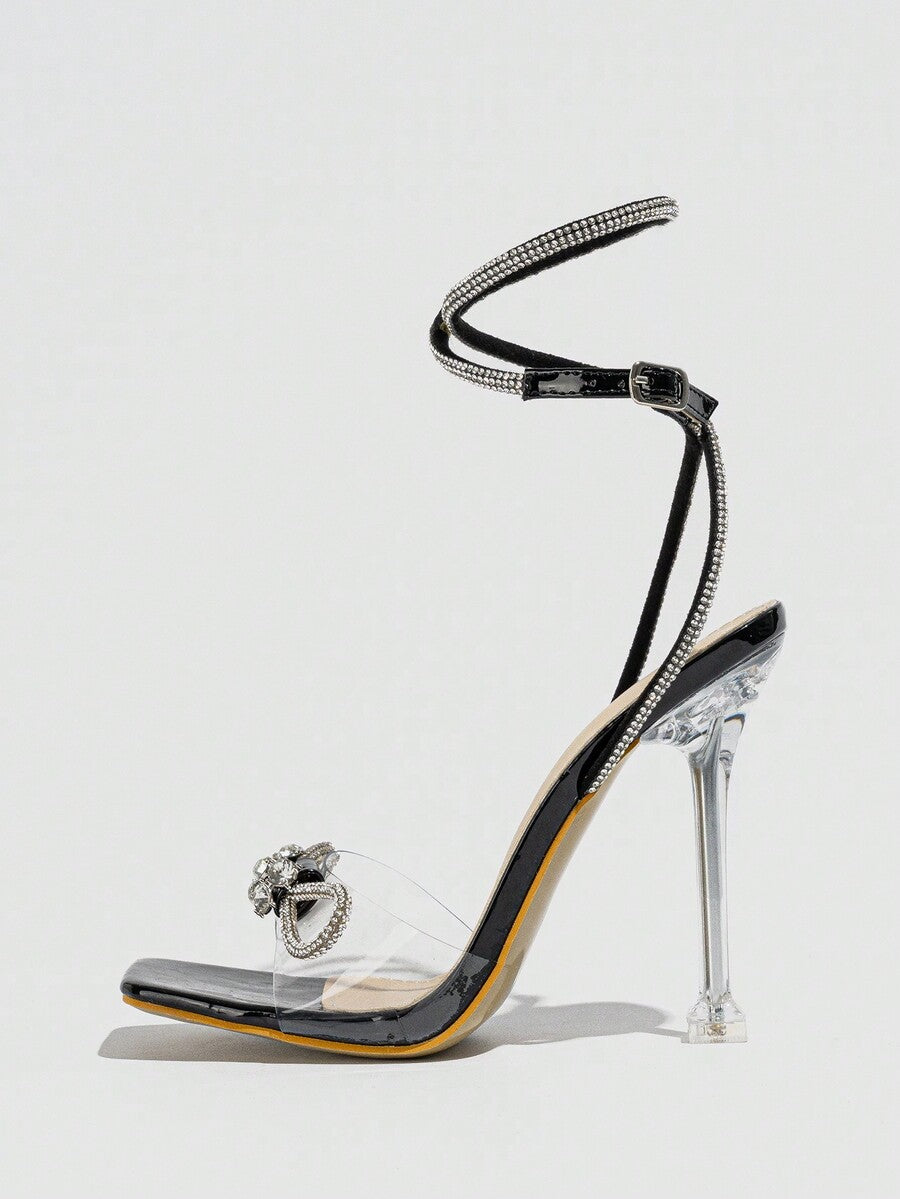 Women's high heel sandals with peep toe, decorative bow, ankle buckle strap, and stiletto heel.