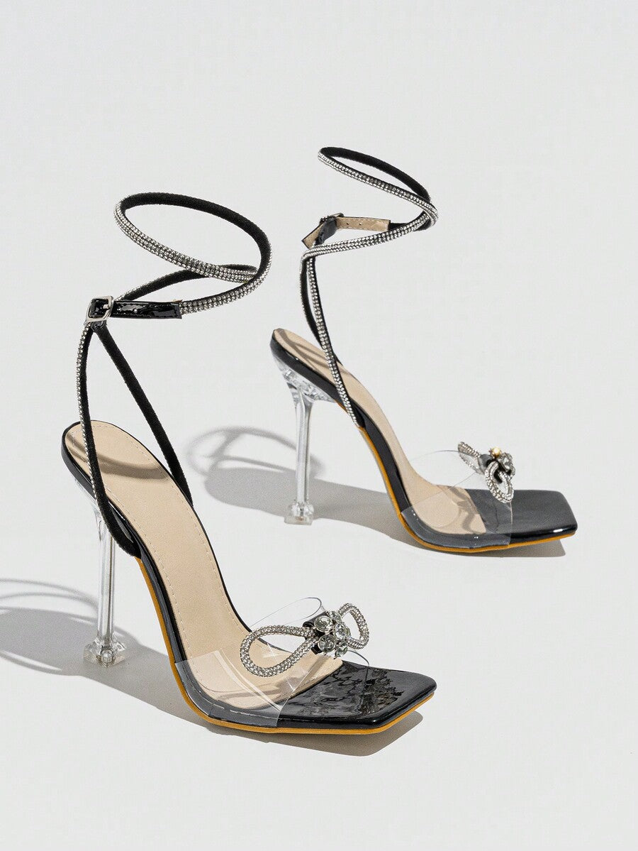 Women's high heel sandals with peep toe, decorative bow, ankle buckle strap, and stiletto heel.