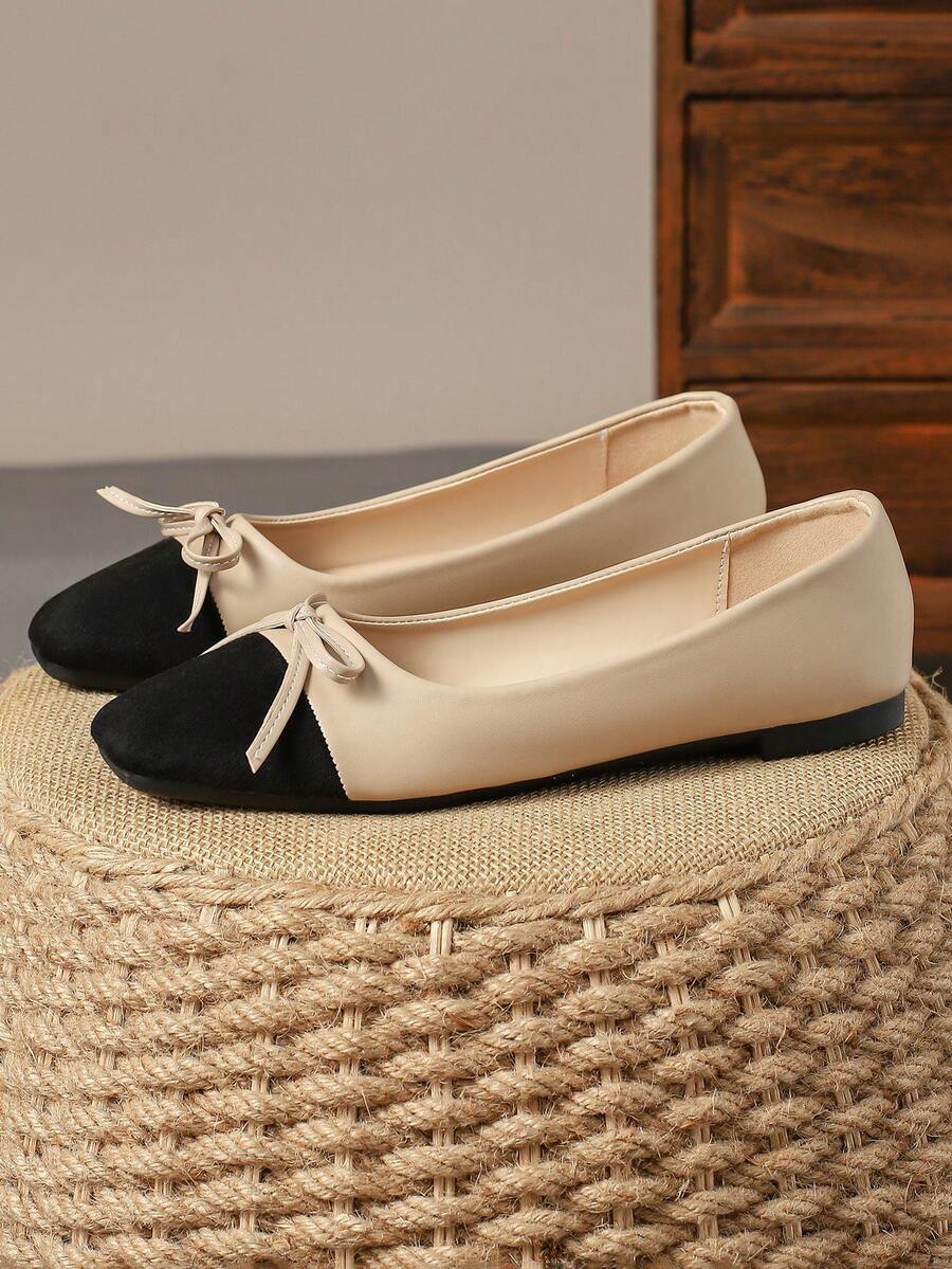 Pair of women's square toe slip-on flat shoes featuring a delicate bow detail and low vamp design.