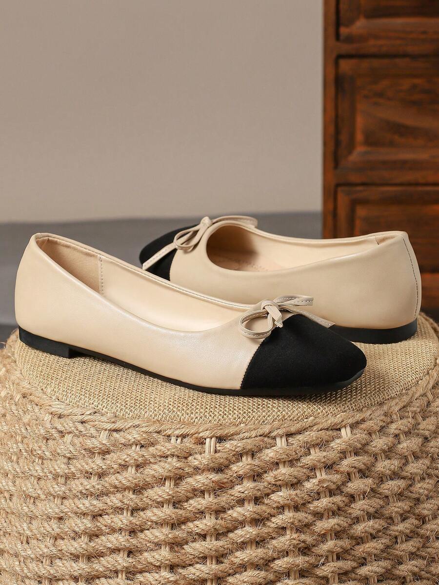 Pair of women's square toe slip-on flat shoes featuring a delicate bow detail and low vamp design.