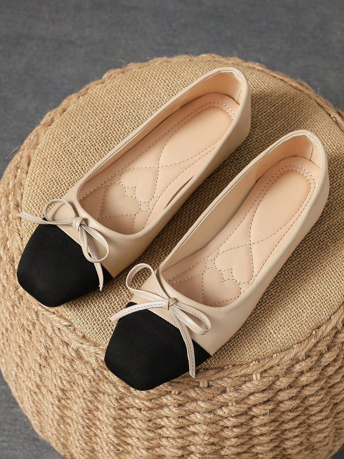 Pair of women's square toe slip-on flat shoes featuring a delicate bow detail and low vamp design.