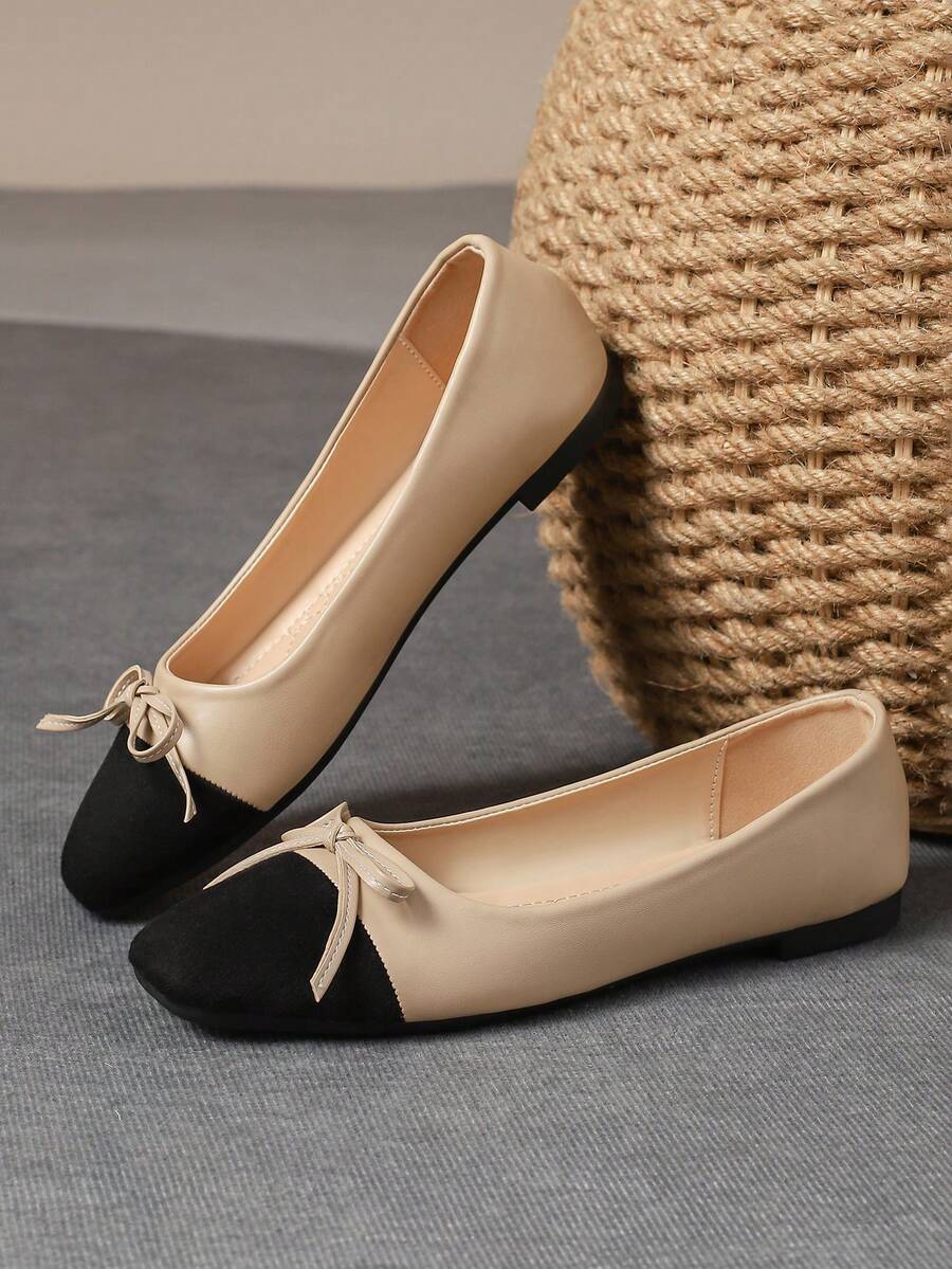 Pair of women's square toe slip-on flat shoes featuring a delicate bow detail and low vamp design.