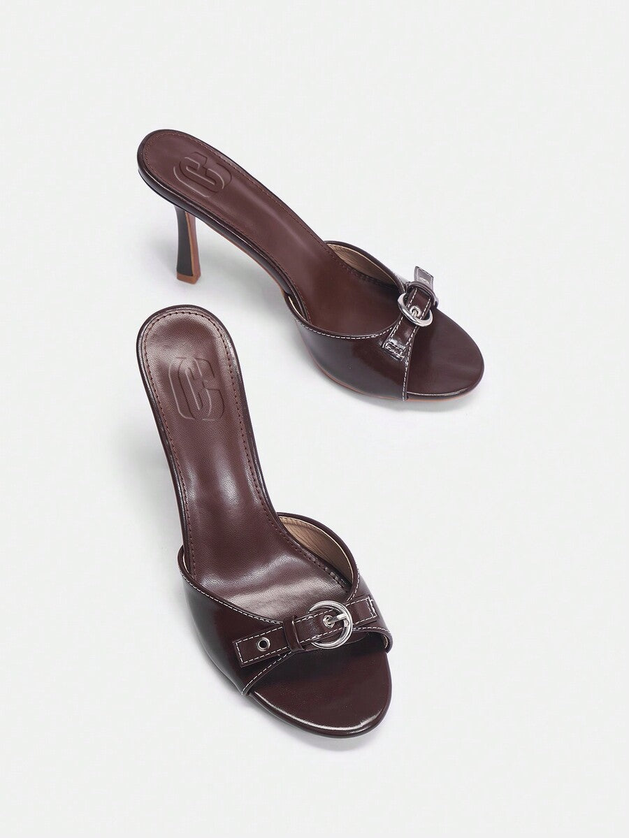 Women's open toe high heel slingback sandals featuring a stiletto heel, buckle strap with grommet eyelets, and smooth PU leather finish.