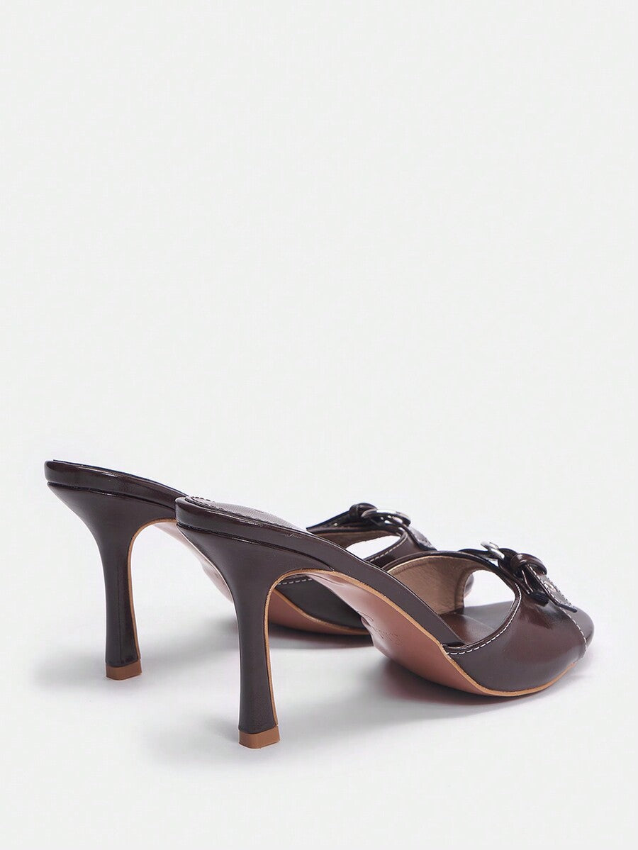 Women's open toe high heel slingback sandals featuring a stiletto heel, buckle strap with grommet eyelets, and smooth PU leather finish.