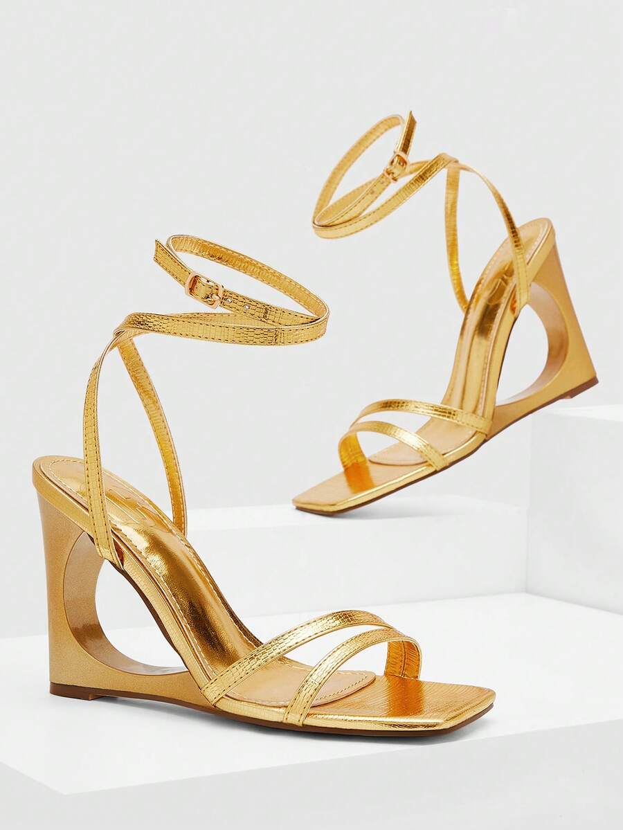 Women's open-toe platform wedge shoes featuring metallic decor and crisscross ankle strap with buckle closure.
