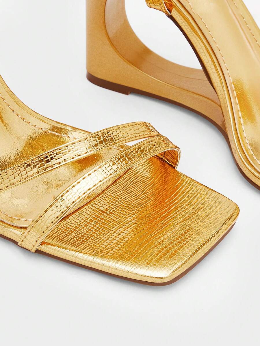 Women's open-toe platform wedge shoes featuring metallic decor and crisscross ankle strap with buckle closure.
