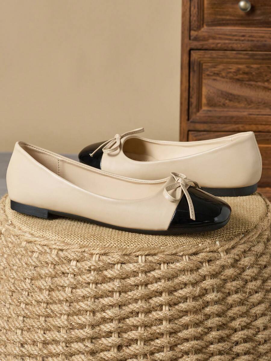 Pair of women's square toe slip-on flat shoes featuring a delicate bow detail and low vamp design.