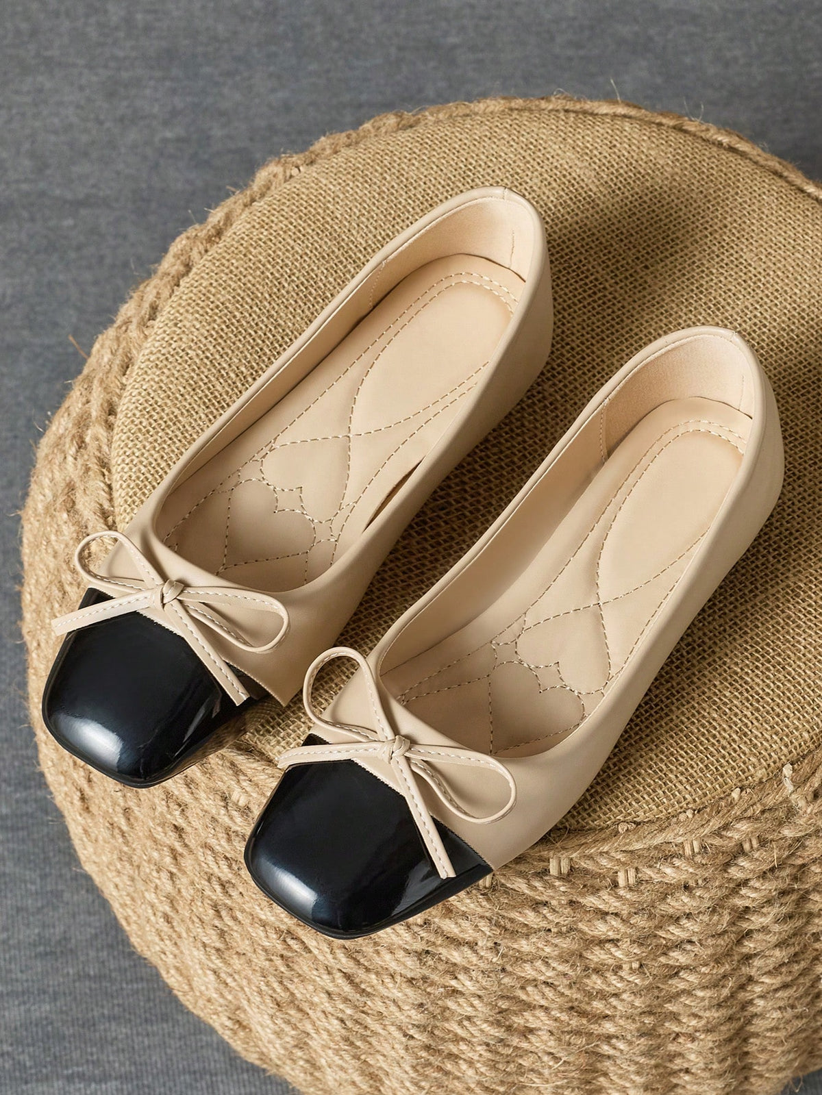 Pair of women's square toe slip-on flat shoes featuring a delicate bow detail and low vamp design.