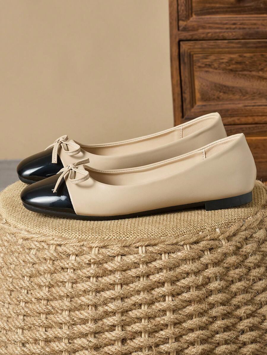 Pair of women's square toe slip-on flat shoes featuring a delicate bow detail and low vamp design.