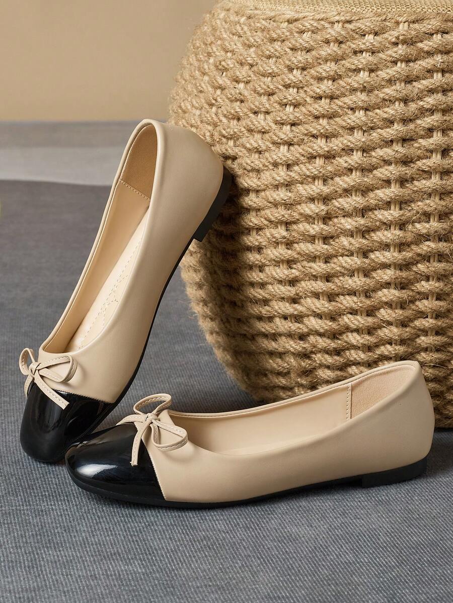 Pair of women's square toe slip-on flat shoes featuring a delicate bow detail and low vamp design.