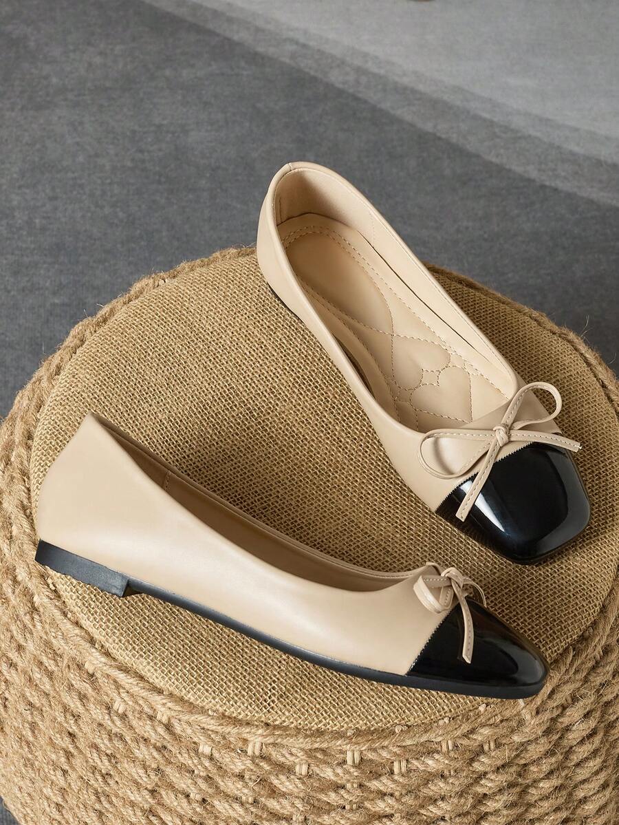 Pair of women's square toe slip-on flat shoes featuring a delicate bow detail and low vamp design.