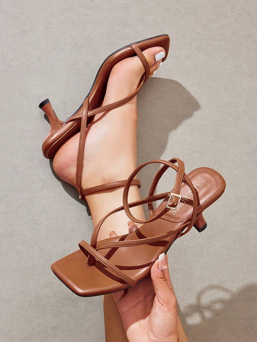 Pair of women's minimalist square toe kitten heeled thong sandals featuring slim ankle straps with buckle closure and sleek low heels.