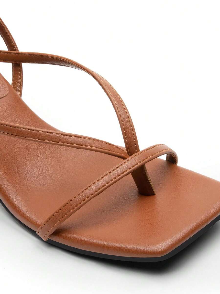 Pair of women's minimalist square toe kitten heeled thong sandals featuring slim ankle straps with buckle closure and sleek low heels.