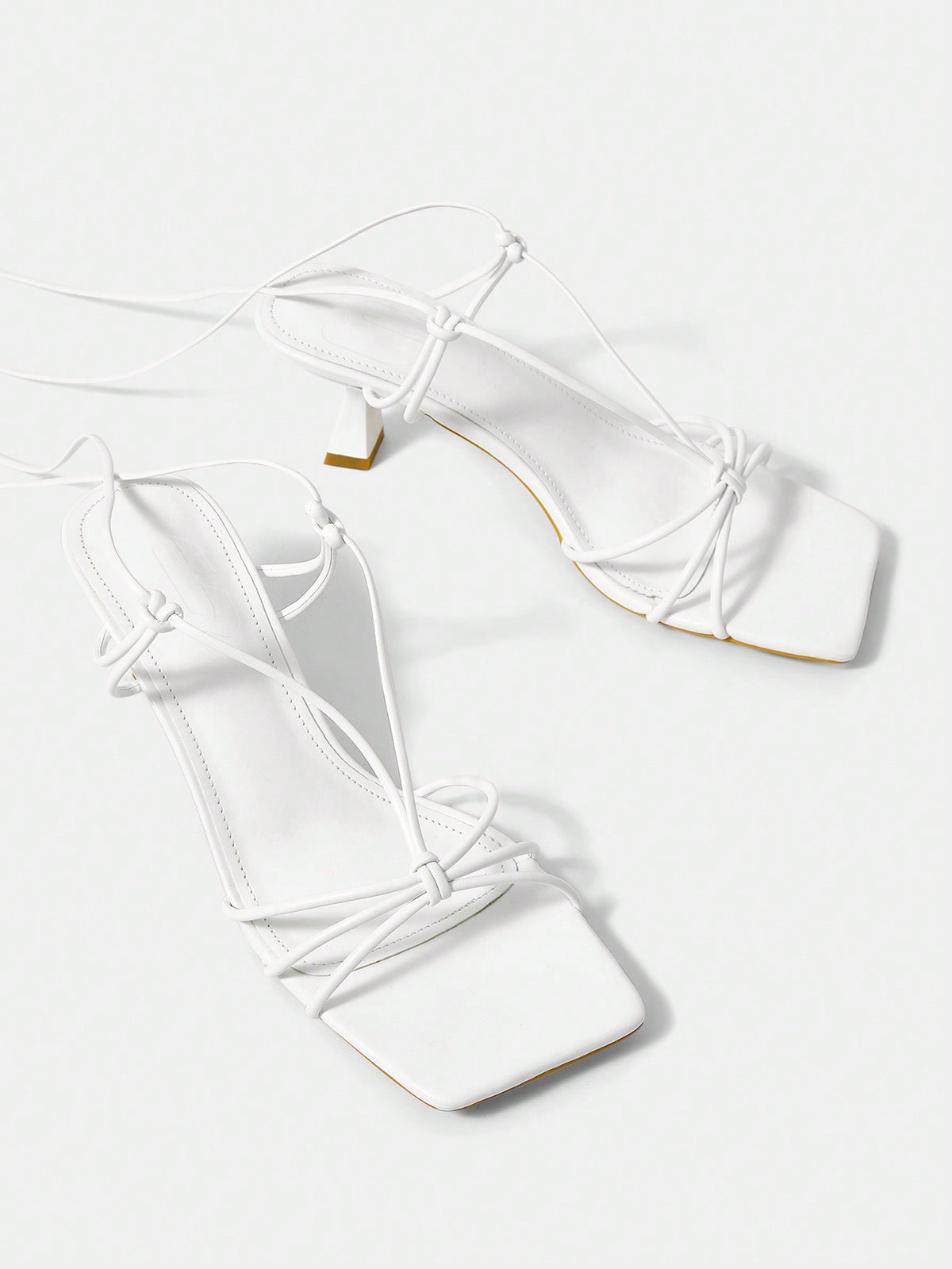Women's square toe stiletto heel slingback sandals featuring sleek straps and buckle closure in a backless design.