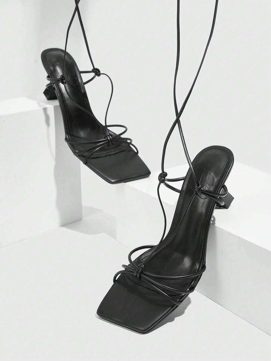 Women's square toe stiletto heel slingback sandals featuring sleek straps and buckle closure in a backless design.
