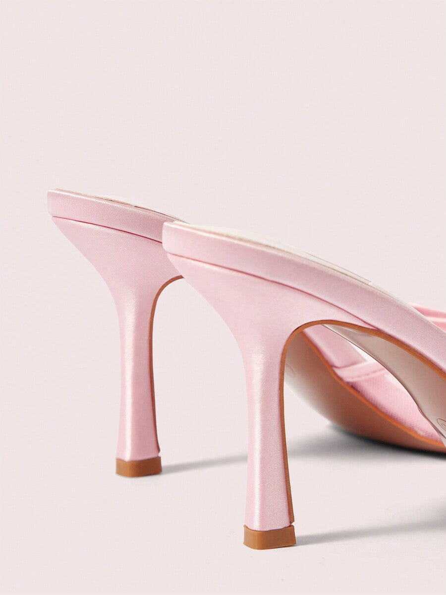 Pair of women's open toe stiletto heeled sandals crafted in satin with a bow accent