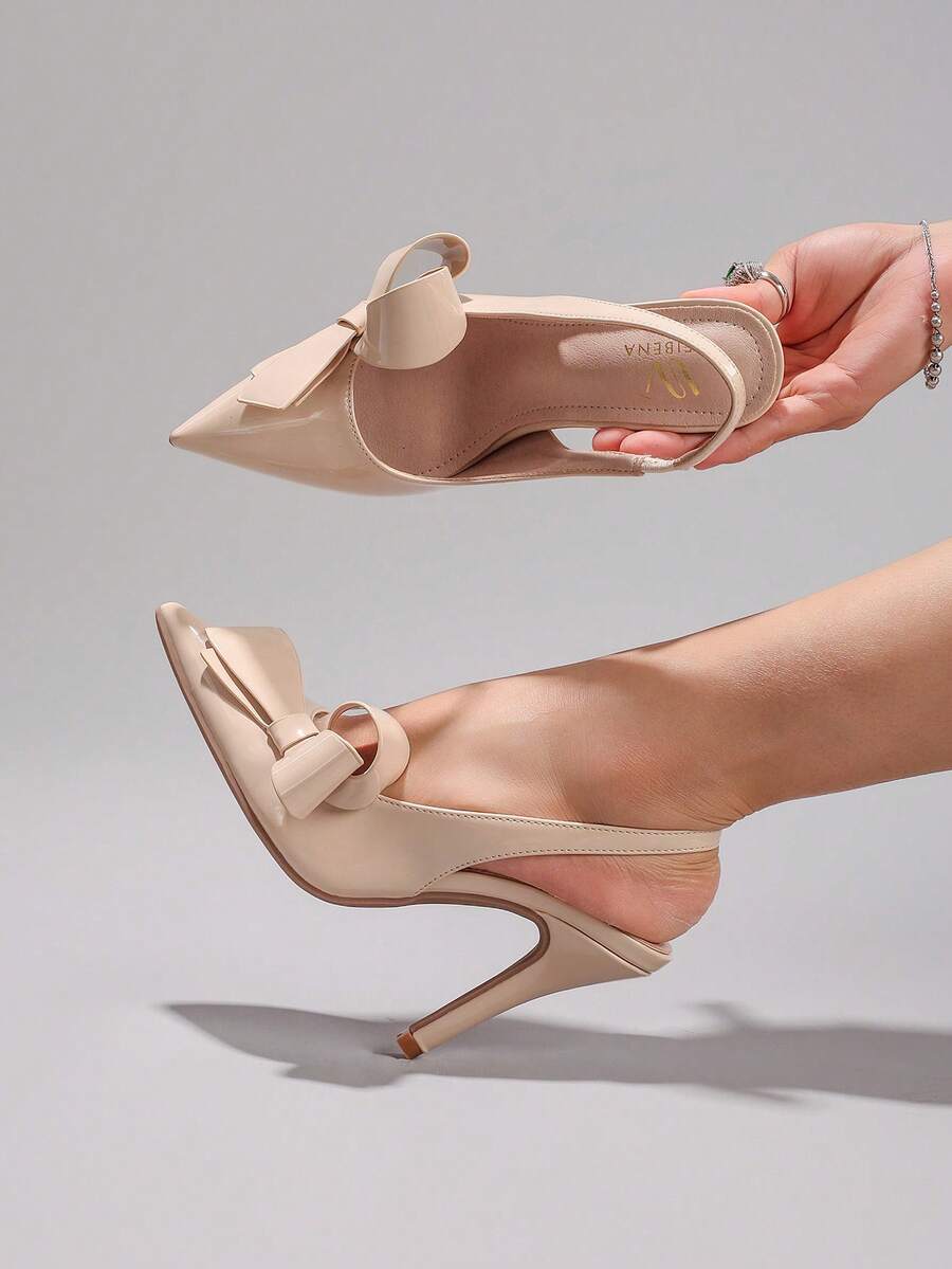 Black lace pointed toe high heel pumps featuring stiletto heels and a decorative bow accent.