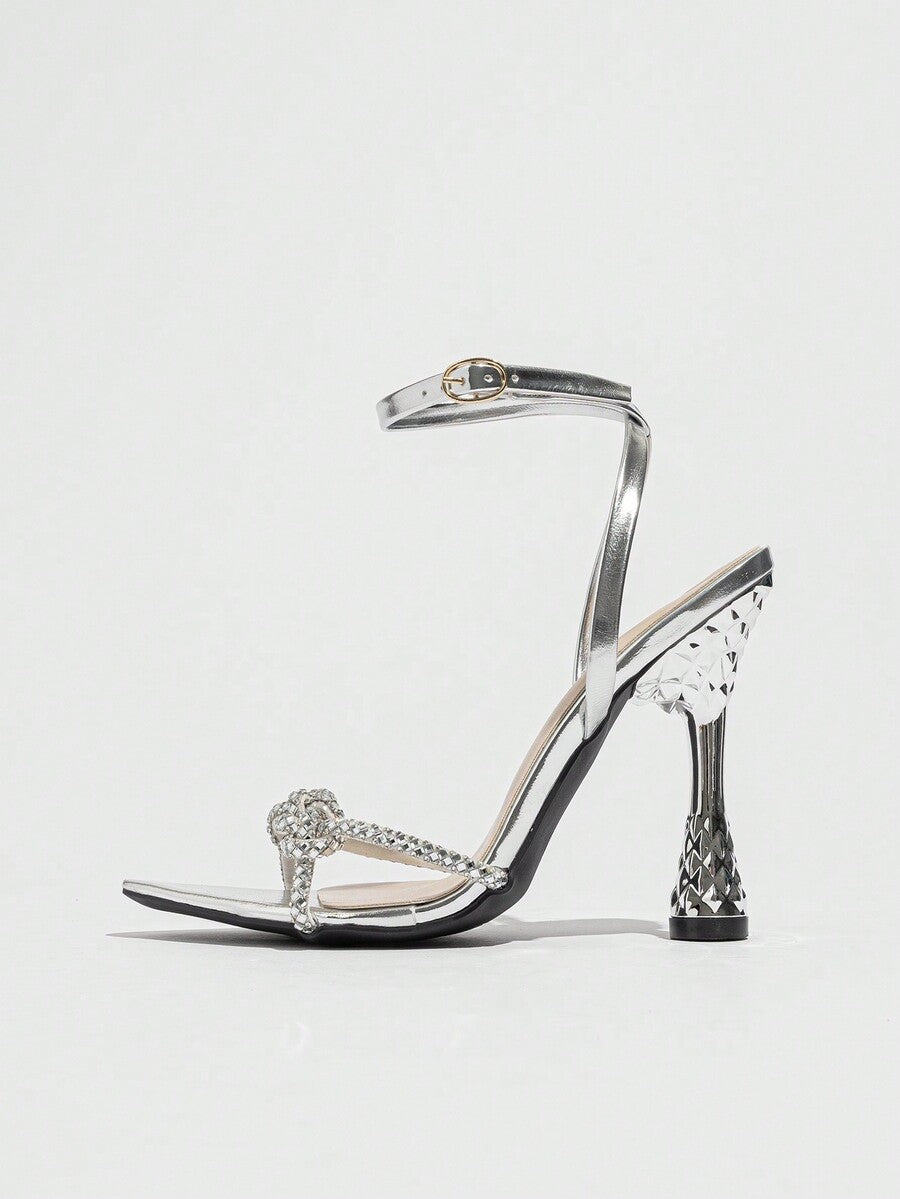 Women's peep toe stiletto high heel strappy sandals with rhinestone accents and slip-on design.