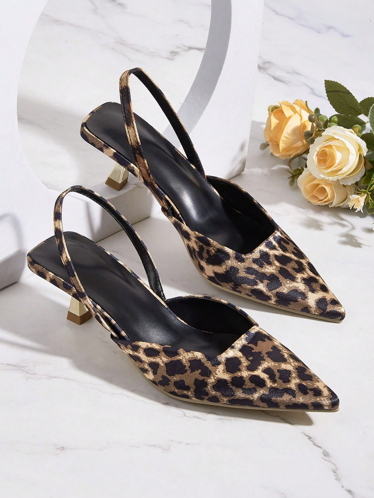 Women's pointed toe kitten heel pumps with leopard print suedette finish and slingback back strap.