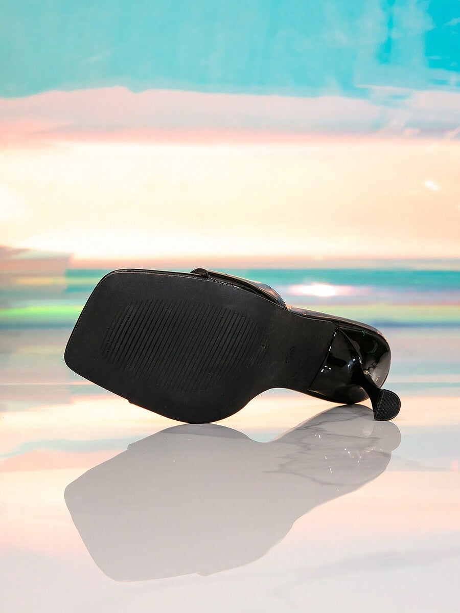 Pair of women's black patent leather square toe high heel mules featuring stiletto heels and open toe slide design.