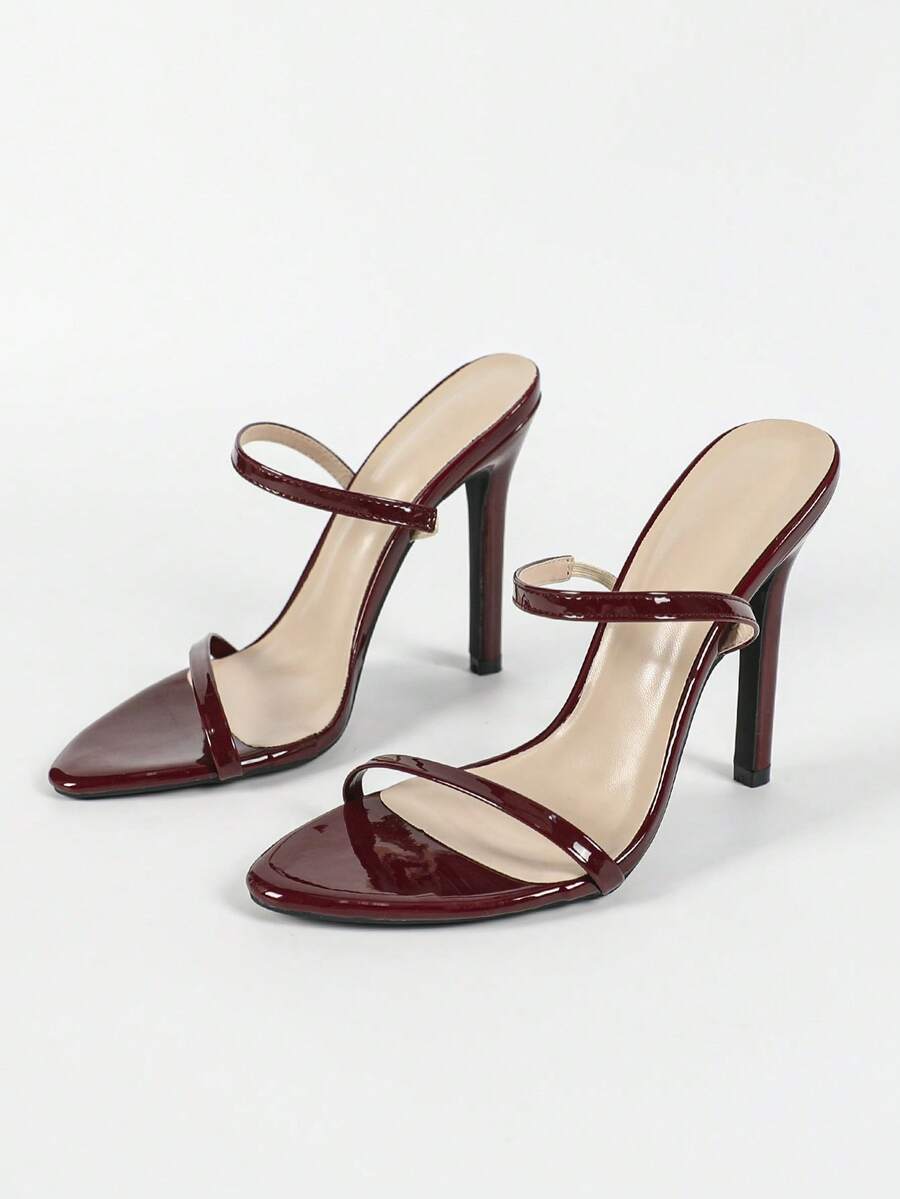 Women's stiletto high heel sandals with round open toe and back ankle strap in solid finish.
