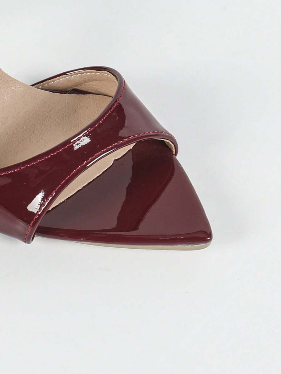Women's black patent strap pointed toe high heel sandals featuring a stiletto heel and open hollow-out slingback design.