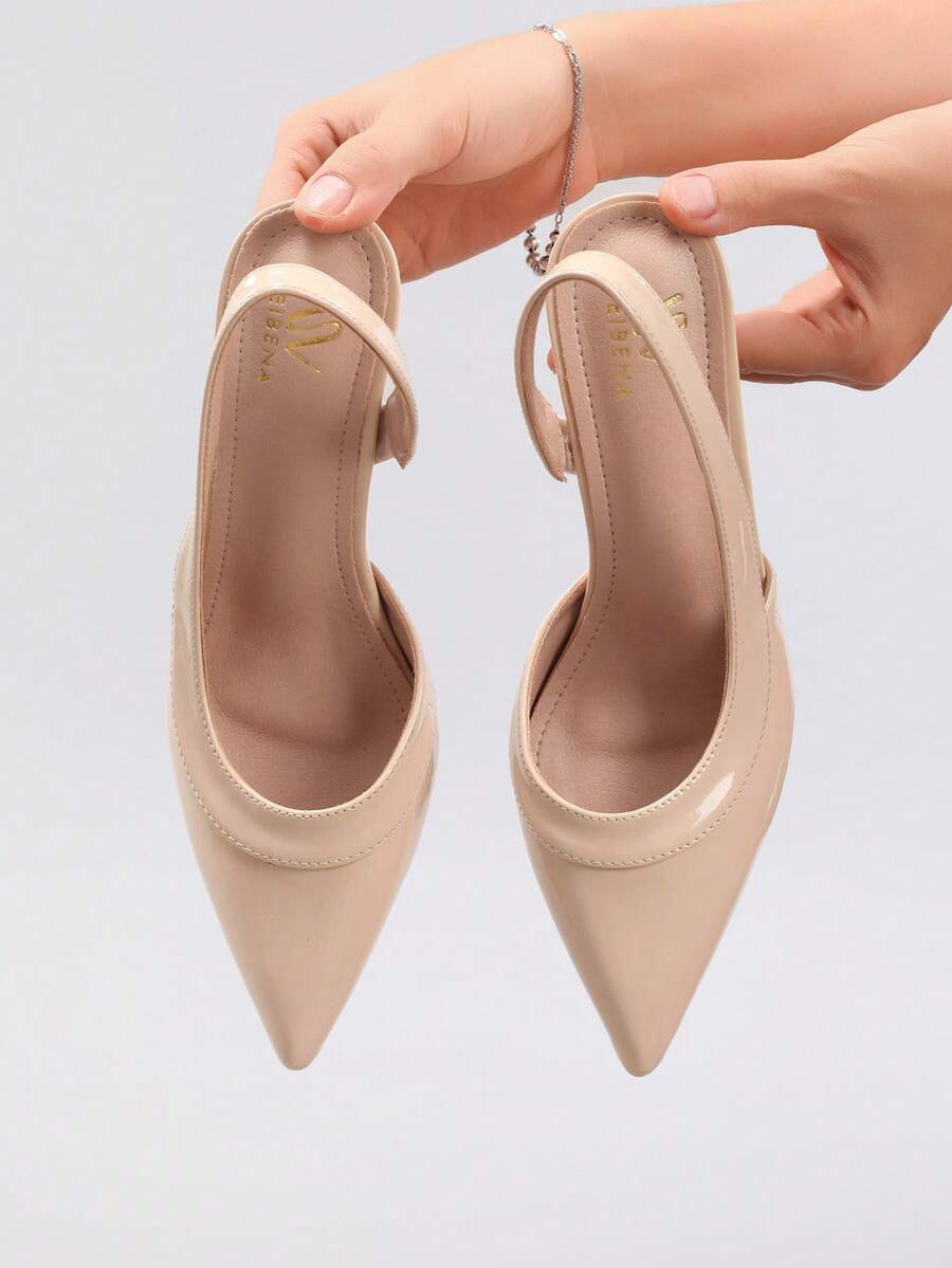 Pair of women's white pointed-toe kitten heel pumps with slingback straps and sleek patent finish